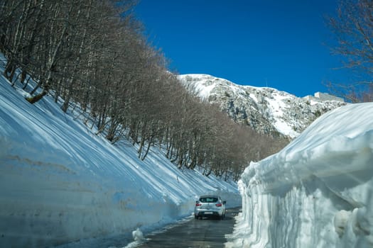 Lovcen National Park, Montenegro - April 2018 : Car driving on a narrow road through the wonderful mountain scenery in winter