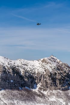 Lovcen National Park, Montenegro - April 2018 : Helicopter flying above telecommunication station on the Stirovnik peak, the highest summit of the Lovcen NP