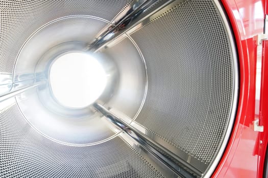close up of industrial laundry machine in a public laundromat