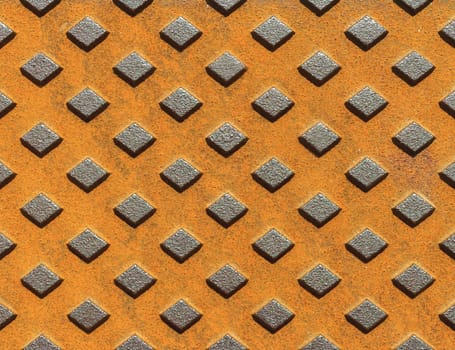 Manhole fragment. Metal rusty texture with geometric pattern.