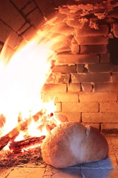 Fire wood burning in an old oven for cooking bread