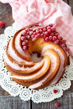 Yummy bundt cake with red currants and pink frosting