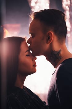guy and the girl kiss closeup on a light background