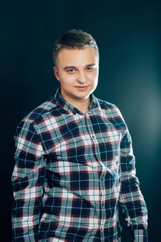 portrait of a young man on a dark background.