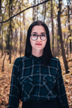 portrait of a young woman in the autumn forest.