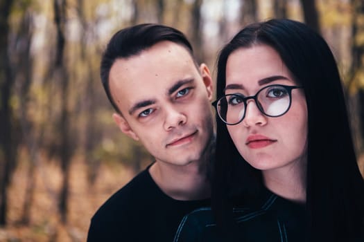 man and woman in the autumn forest