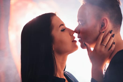 guy and the girl kiss closeup on a light background