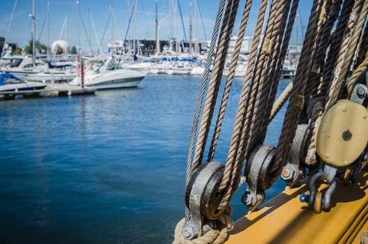 Rigging on the old sailboat against the background of modern yachts