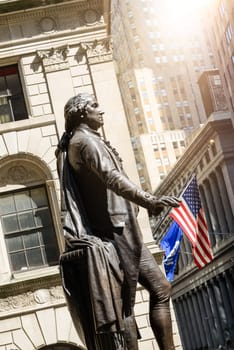 Famous Wall street and the building in New York, New York Stock Exchange with patriot flag
