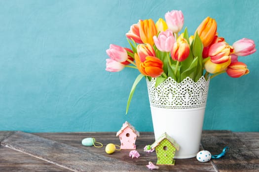 Bunch of fresh colorful tulips with easter decorations