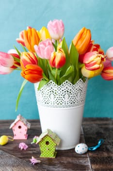 Bunch of fresh colorful tulips with easter decorations