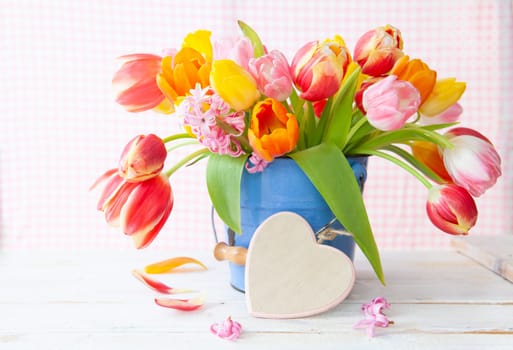 Bunch of fresh colorful tulips and a little heart
