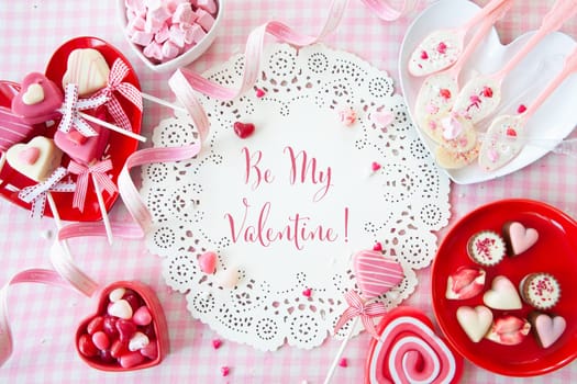 Yummy sweets and chocolates in a heart shape and pink
