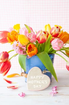 Bunch of fresh colorful tulips and a little heart