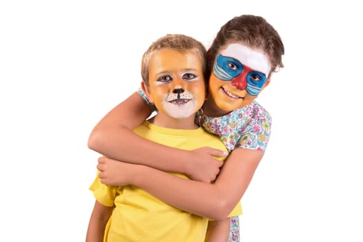 Children's couple with animal face-paint isolated in white