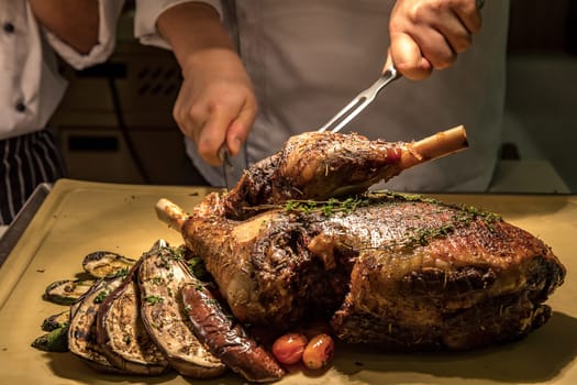 Carving of Roasted lamb meat