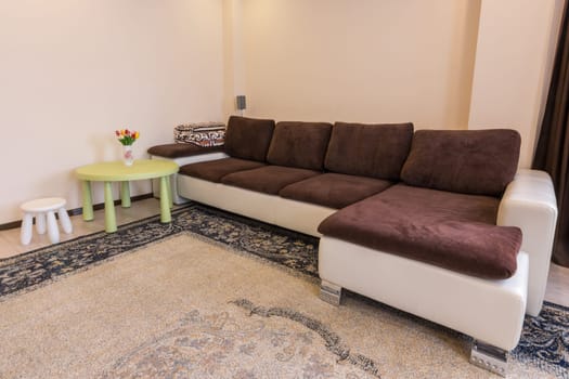 Interior living room, large sofa table and stool