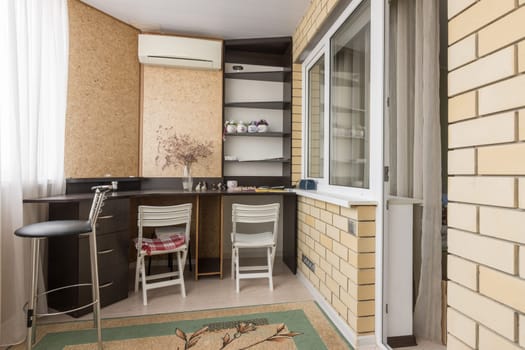 Equipped working area on the spacious balcony of the apartment