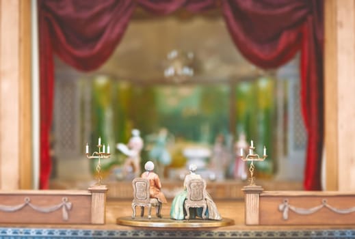 Miniature toys watching theater performance. Scene made of vintage figurines