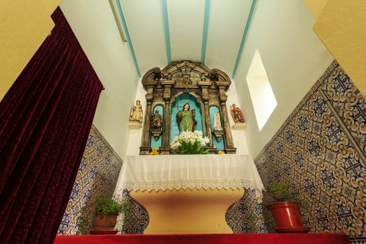 View of the beautiful 18th century Baroque wooden altarpiece of the Chapel of St John the Evangelist, in Luso, Portugal