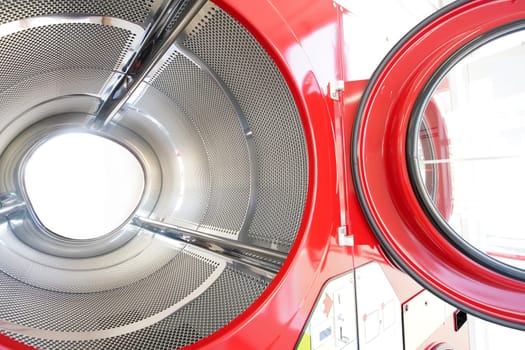 close up of industrial laundry machine in a public laundromat