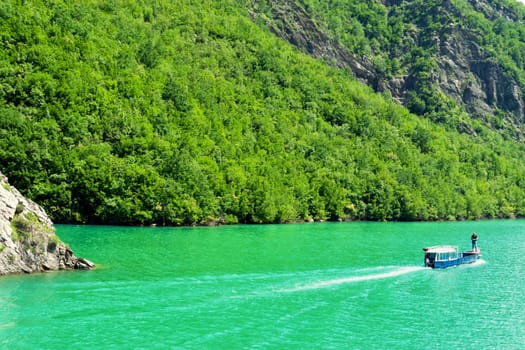 KOMAN LAKE, ALBANIA - MAY 26: View of the mountains and lake in the  Koman Reservoir in Albania on May 26, 2018.