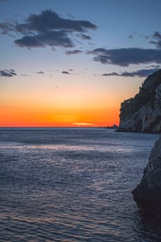 Beautiful sunset over the cliffs in Petrovac coast, Montenegro