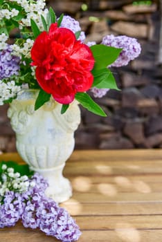 Bouquet with lilac and peony roses.
