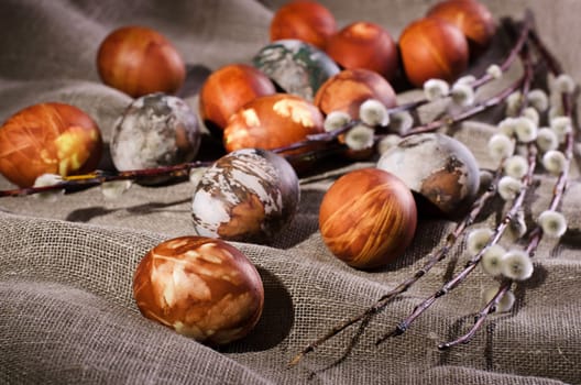 Easter eggs. Painted eggs with pussy willow on the brown linen cloth.