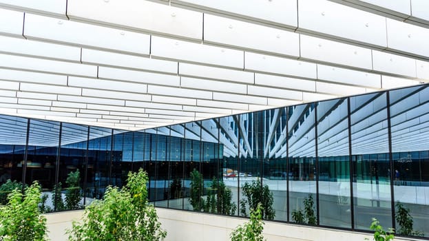 Long lines, mirrors and wide plans creating open spaces in modern architecture..Location: EDP Headquarters in Lisbon, Portugal.