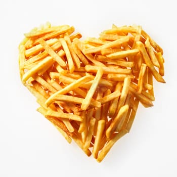High-angle studio shot close-up of a portion of salty French fries in heart shape on white background for copy space