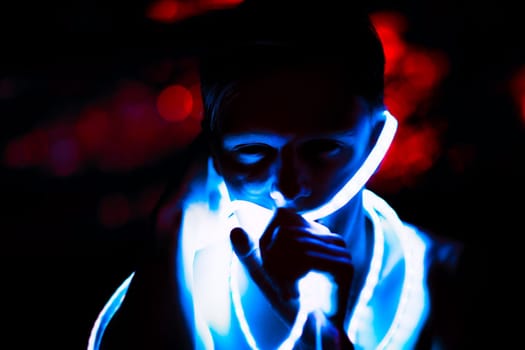 Portrait man Strip Light LED tape on dark color background.