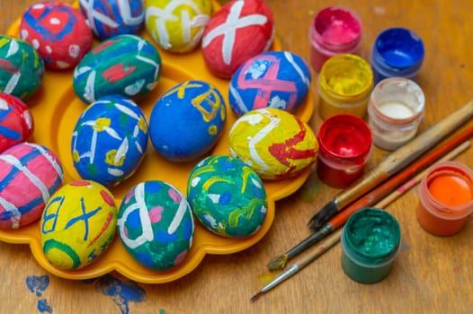 Painting Easter eggs with paints and a brush