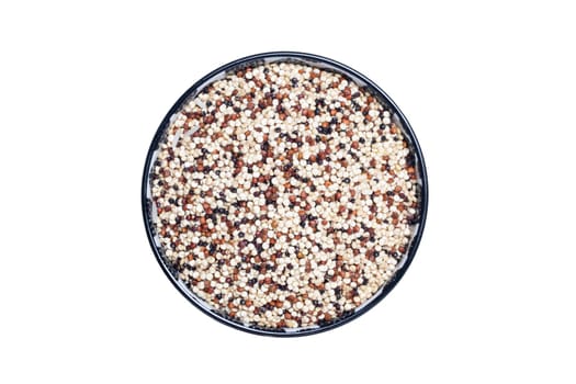 Vegetable food. Macro of a bowl with uncooked raw tricolor quinoa grains isolated on a white background. Healthy eating. Top view with space for product montage.