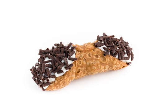 Sweet cannolo stuffed with ricotta cheese cream and chocolate flakes. Traditional Sicilian dessert.