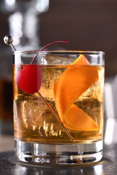 Cocktail Old Fashioned is an old-fashioned sophistication of whiskey and sweet syrup. Served with ice, orange zest and Maraschino cherry. 