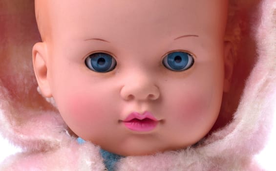 Very old baby doll (1940s), made with authentic clothing, isolated