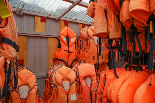 Room with orange Life Belts hanging in a row