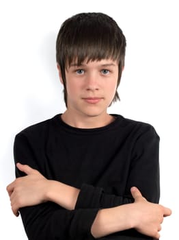 Portrait of serious teenager in black shirt with crossed hands on the chest