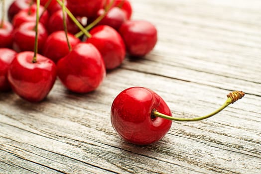 Fresh red cherries on wooden table close up
