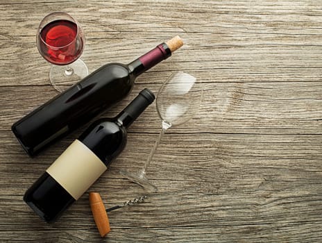 Glass and bottle of red wine on wooden background. Wine bottle mockup. Top view