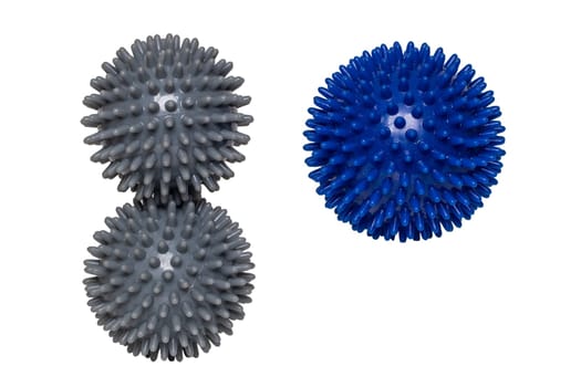 Massage ball or hedgehog ball. Closeup of three spiky massage balls for health therapy isolated on a white background. Therapy and fitness equipment.