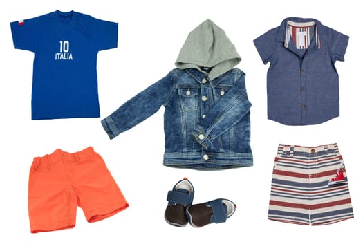 Set of spring and summer fashion for child boy. Beautiful jeans jacket, shirts, short pants and shoes.  Isolated on white.