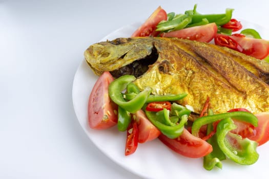 Fried fish on white background with selective focus