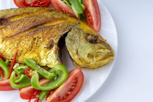 Fried fish on white background with selective focus