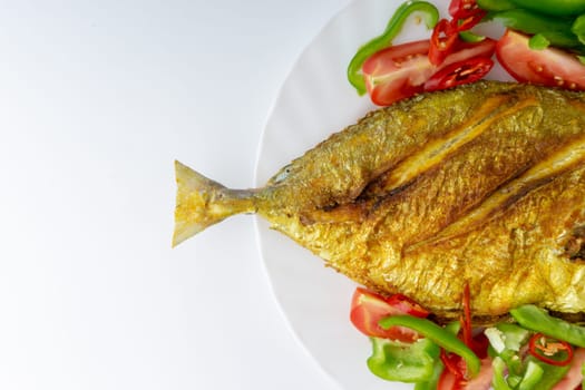 Fried fish on white background with selective focus