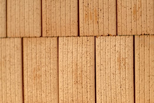 Red brick wall on a construction site with blurred areas as a background