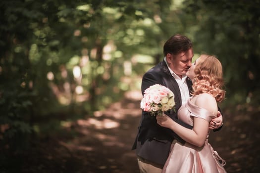 bride and groom dancing in the forest background and sunlight.