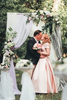 bride and groom on wedding ceremony on background nature.