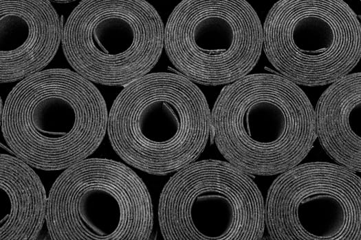Closeup of Rolls of new black roofing felt or bitumen. Shallow depth off field
